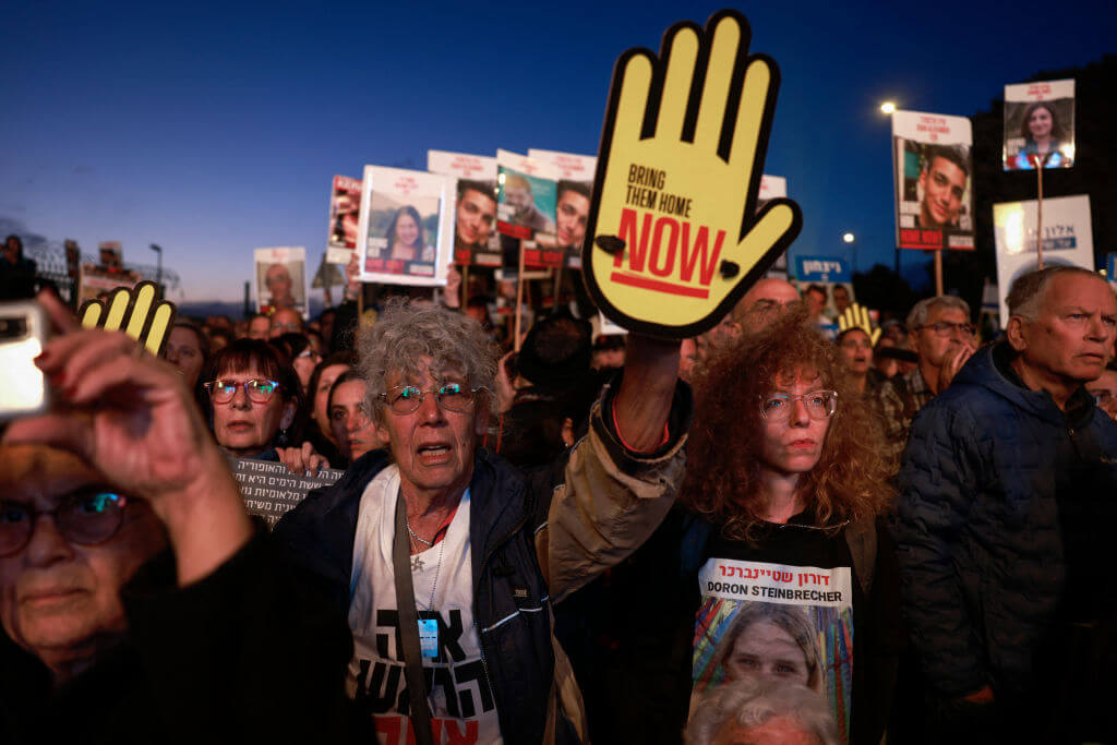 Relatives and supporters of Israeli hostages held in Gaza since the October 7 attacks by Hamas militants lift placards during a demonstration in front of the Israeli parliament in Jerusalem on April 7, 2024.
