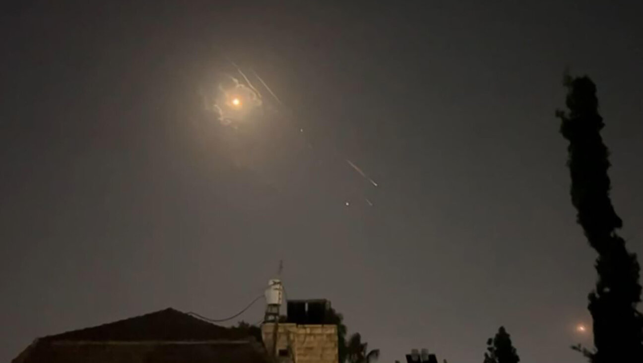 Explosions lit up the sky over Jerusalem as missile defense systems worked to intercept an Iranian attack on Israel.