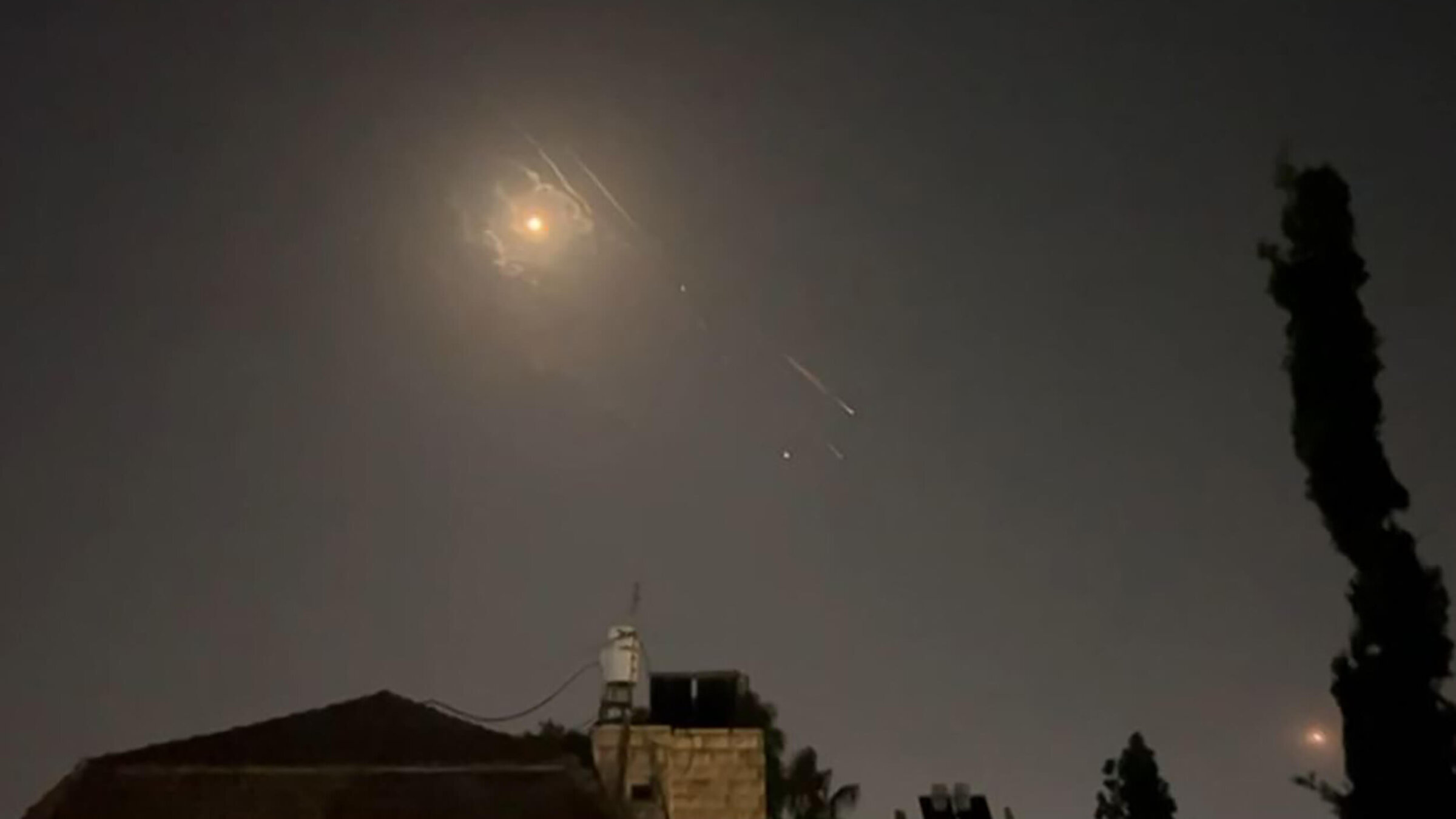Explosions lit up the sky over Jerusalem as missile defense systems worked to intercept an Iranian attack on Israel.