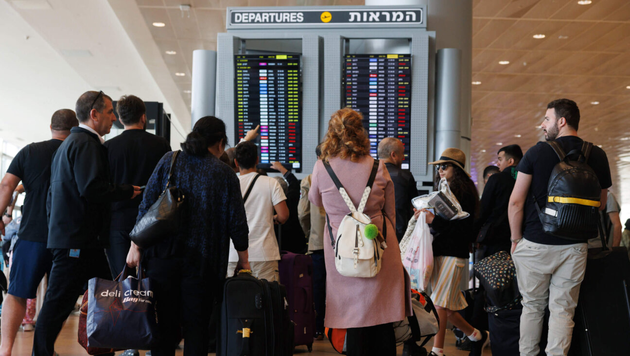 Passengers check their flight status at Ben-Gurion International Airport on the morning after Iran attacked Israel with drones and missiles on Sunday, April 14.