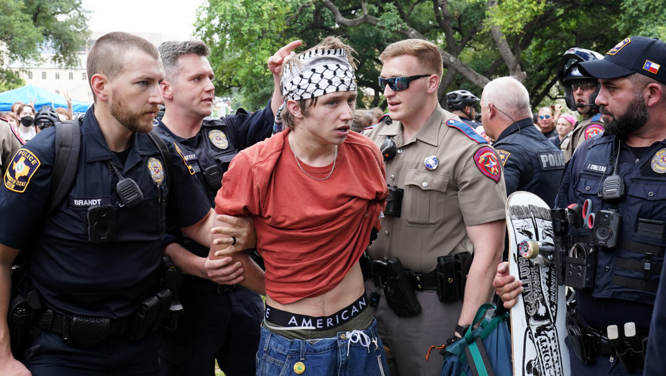 A person is detained by police as pro-Palestinian students protest on the campus of the University of Texas at Austin April 24.