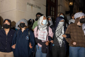 Demonstrators lock arms to prevent authorities from reaching fellow protestors who barricaded themselves inside Hamilton Hall at Columbia University.