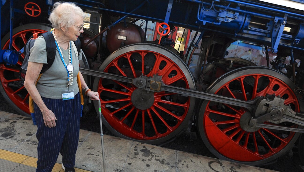 Survivor Hanna Slome looks at a historical train in Prague named ”Winton” after the British stockbroker who helped save her and 668 other children during the Holocaust on Sept. 1, 1999. (AFP Phto/Michal Cozen via Getty Images)