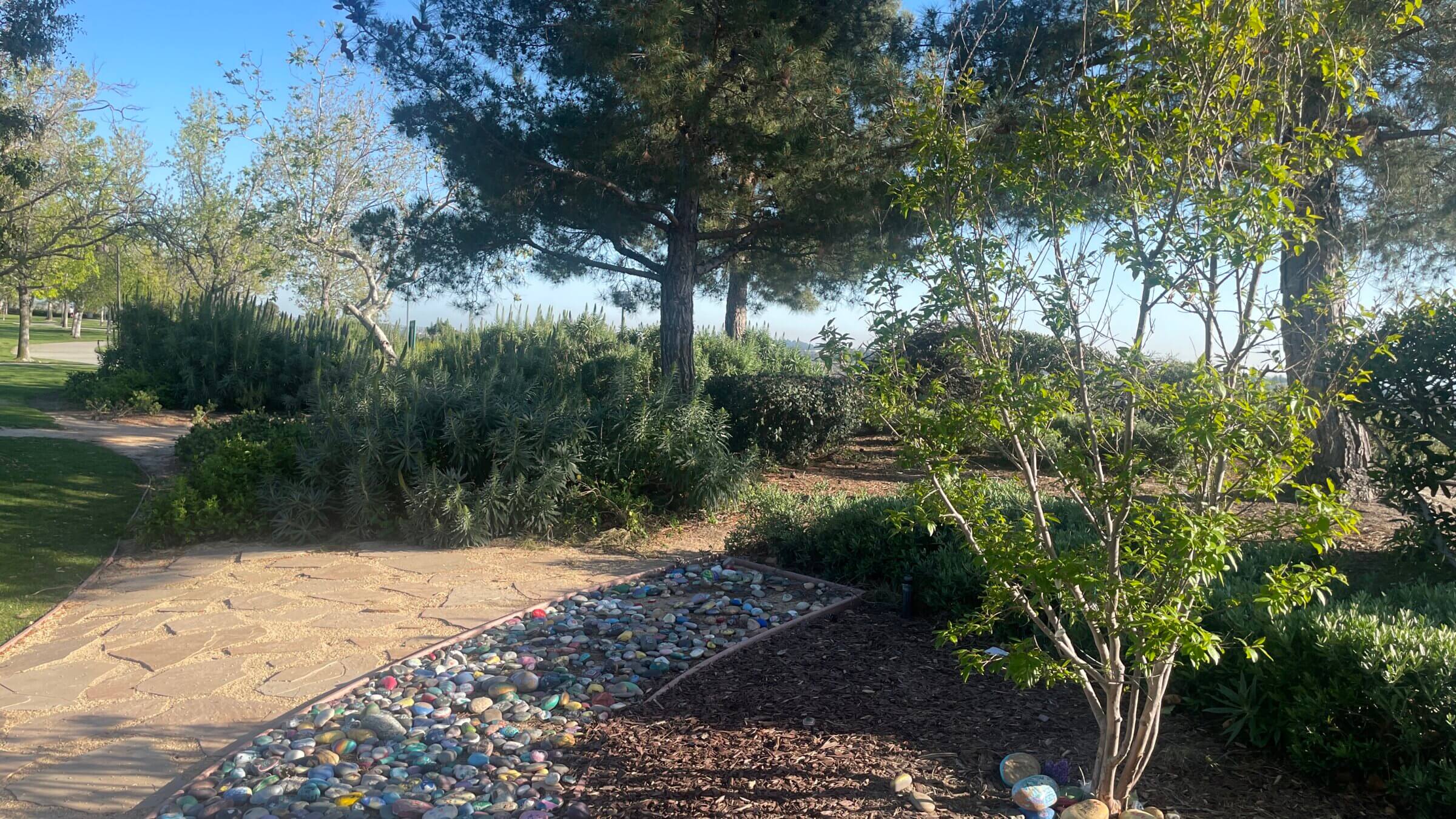 Painted rocks decorate a memorial for Blaze Bernstein at Borrego Park in Lake Forest, California. On June 20, Samuel Woodward described killing and burying Bernstein in the park.