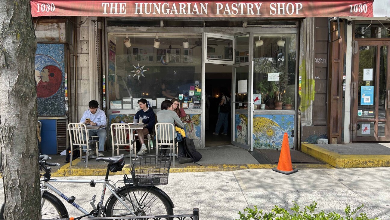 People sit and chat outside the Hungarian Pastry Shop, a popular cafe a few blocks away from Columbia's campus in Morningside Heights
