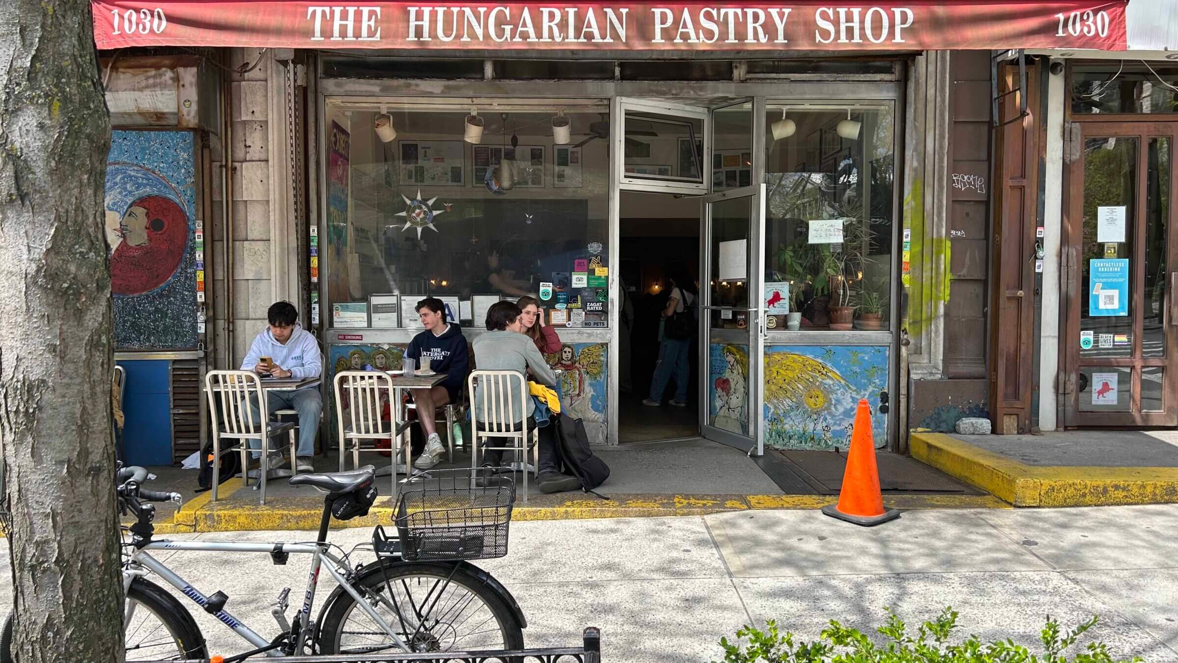 People sit and chat outside the Hungarian Pastry Shop, a popular cafe a few blocks away from Columbia's campus in Morningside Heights.