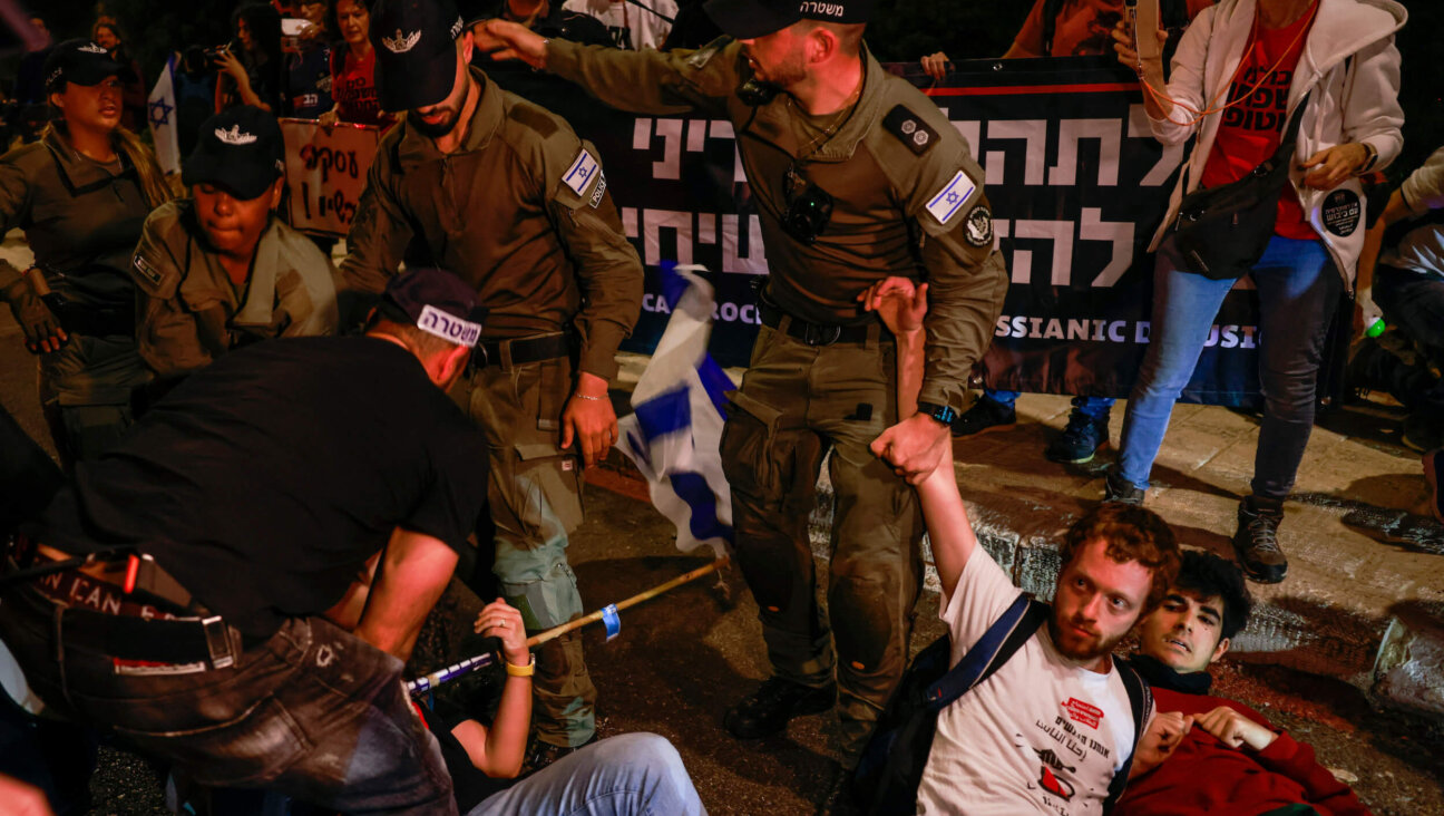 Israeli forces arrest anti-government protesters blocking a road in Jerusalem on Monday during a sit-in near the Knesset calling for Netanyahu's ouster. 