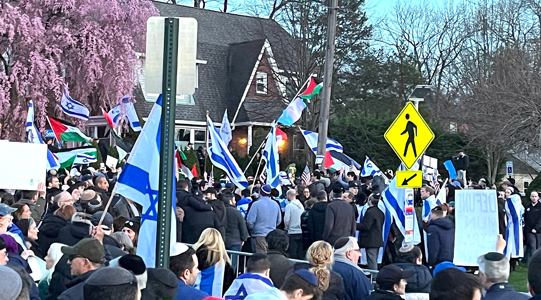 Teaneck, New Jersey’s Jewish community turned out in force to counter a pro-Palestinian demonstration, seen at rear, April 1, 2024. (JTA photo)