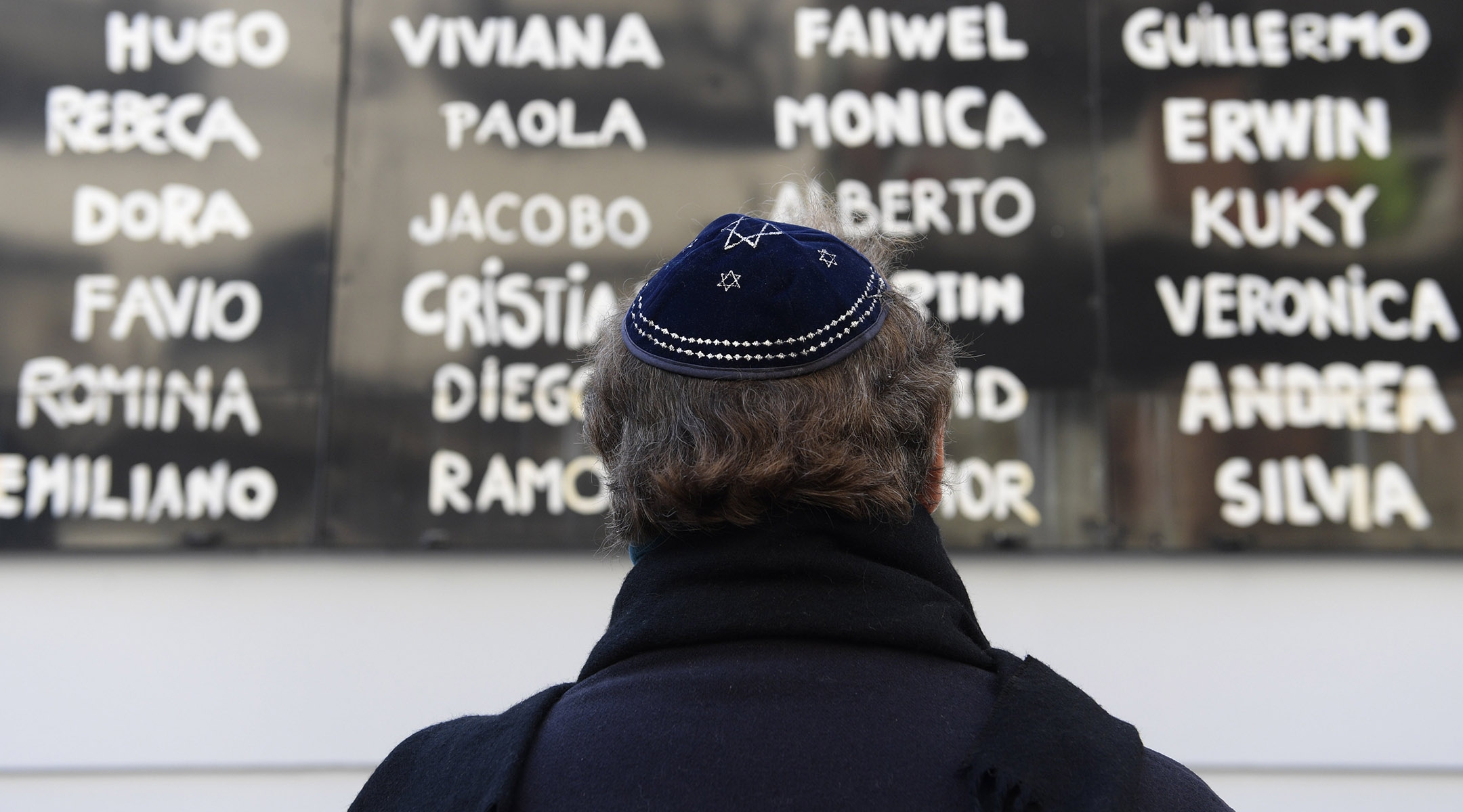 A man prays in front of the AMIA Jewish center during the commemoration of the 23rd anniversary of the terrorist bombing in Buenos Aires, July 18, 2017. (AFP/Juan Mabromata / Getty Images)