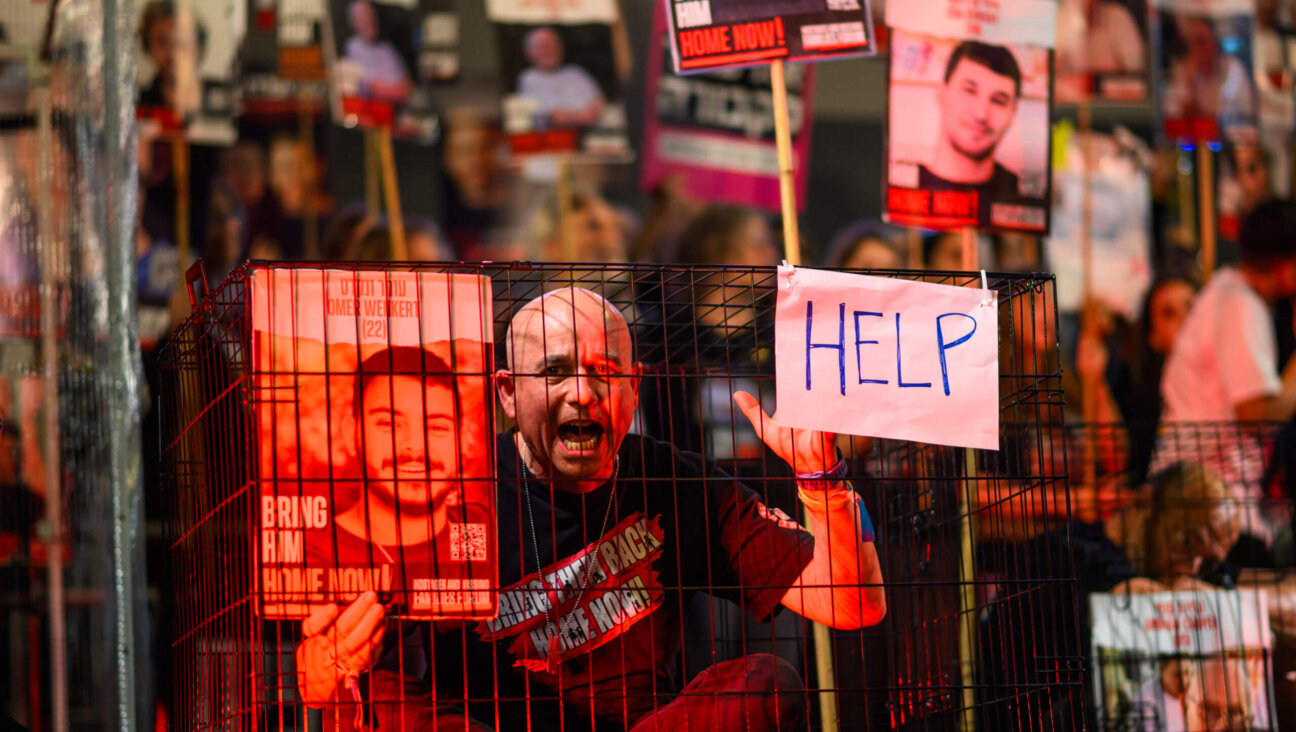 A protestor sitting in a cage screams during the 'Bring them home now' rally, March 30 in Tel Aviv, Israel. According to the families of hostages forum, this would be the last week a rally is held at Hostages Square, citing that the government is not serious about negotiations, and instead, will be joining anti-government protests.