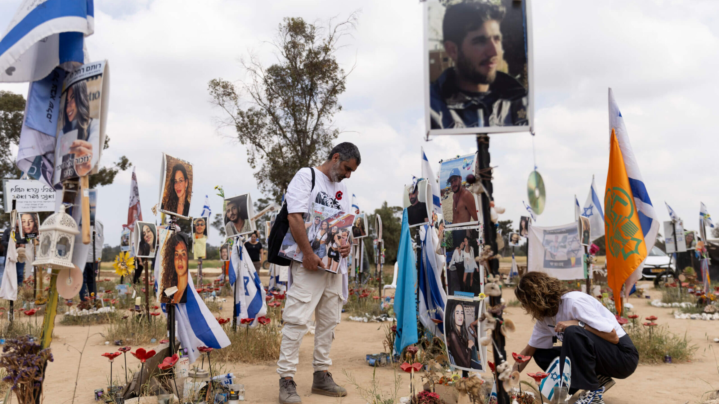 Sigal Manzuri and Amit Cohen visit the marker of their daughters Norelle and Roya who were killed on the Oct. 7 Hamas deadly attack at the Nova music festival on April 7, 2024 in Re'eim, Israel. 