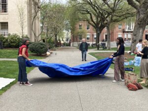 Students from Brown University's encampment fold a tarp as they break their protest down, after reaching an agreement with the university administration.