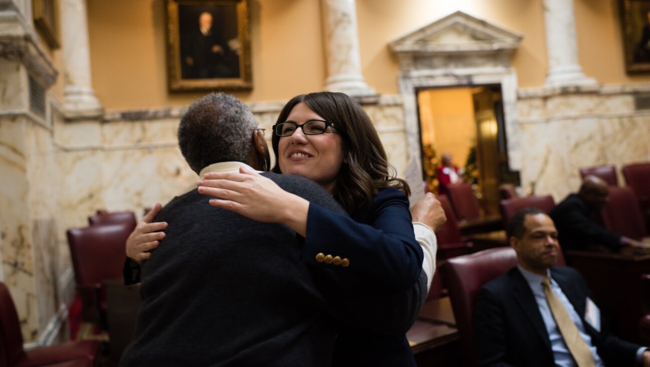 Maryland State Sen. Sarah Elfreth, right, a Democrat and the youngest woman to ever serve in the Maryland state Senate, hugs Joy Walker, the Office administrator for Senator Thomas V. Miller Jr., the president of the Maryland Senate, on Dec. 6, 2018. (Sarah L. Voisin/The Washington Post via Getty Images)