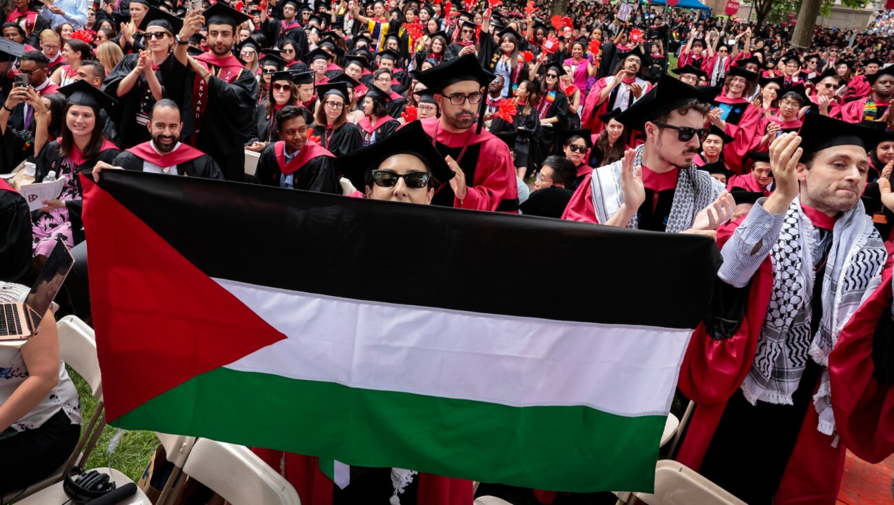 A graduate displays a Palestinian flag during the 373rd Commencement at Harvard University, Cambridge, Massachusetts, May 23, 2024. (Craig F. Walker/The Boston Globe via Getty Images)