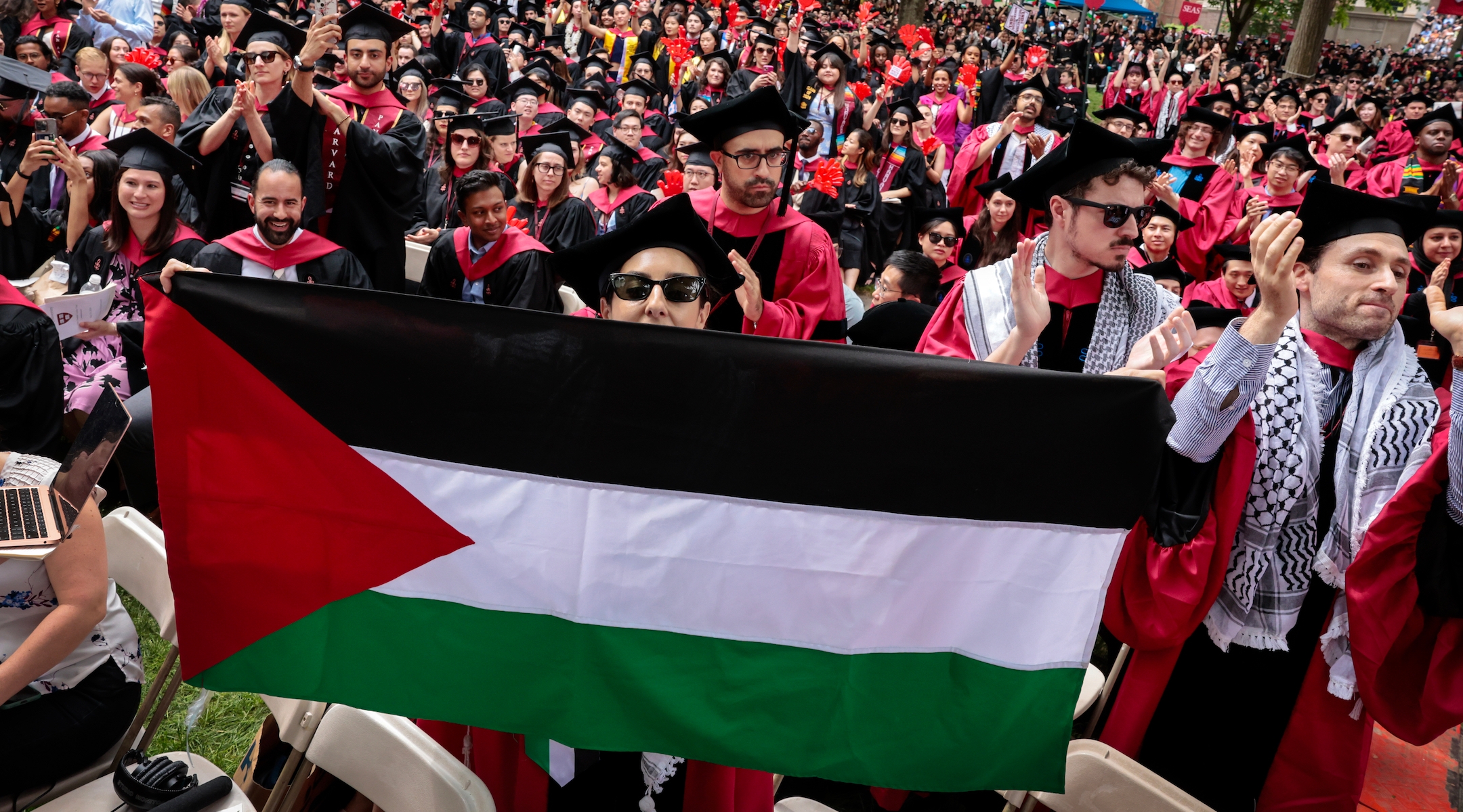 A graduate displays a Palestinian flag during the 373rd Commencement at Harvard University, Cambridge, Massachusetts, May 23, 2024. (Craig F. Walker/The Boston Globe via Getty Images)