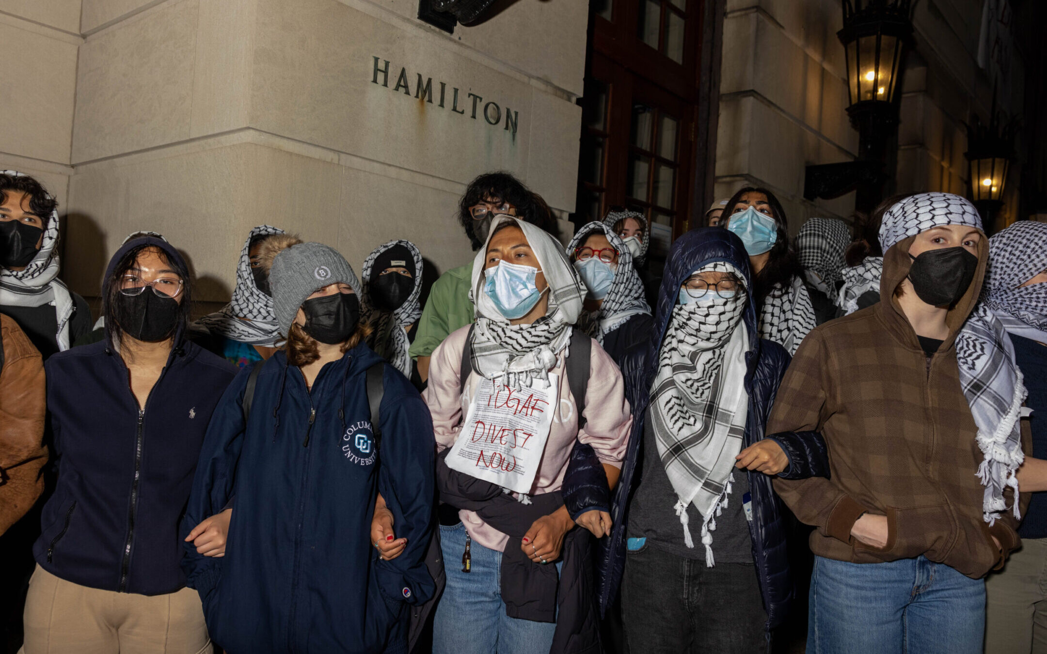Students/demonstrators lock arms to guard potential authorities against reaching fellow pro-Palestinian protesters who barricaded themselves inside Hamilton Hall, an academic building which has been occupied in past student movements, April 29, 2024. (Alex Kent/Getty Images)