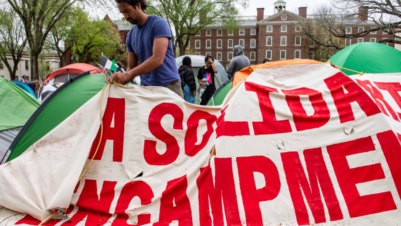 Pro-Palestinian students take down their encampment after reaching a deal with Brown University in Providence, Rhode Island on April 30, 2024. (Joseph Prezioso/AFP via Getty Images)