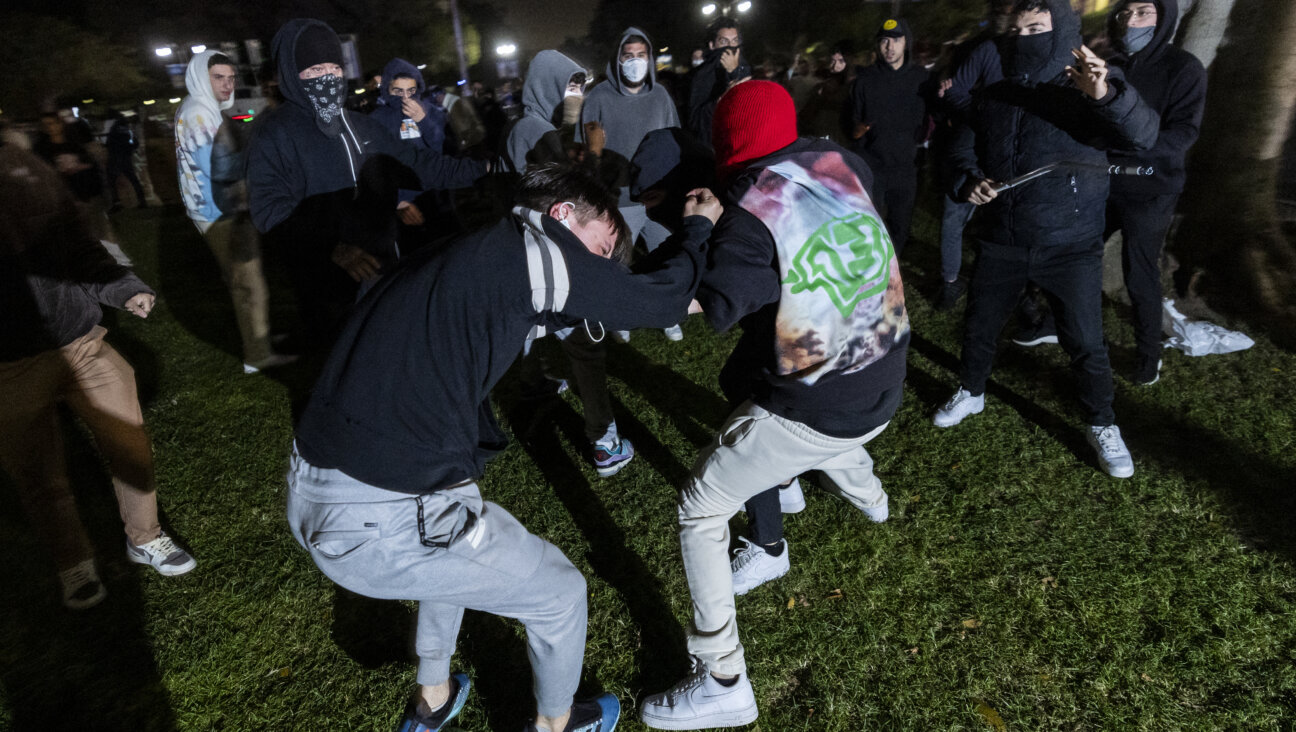 A pro-Palestinian demonstrator is beaten by counter protesters attacking a pro-Palestinian encampment at UCLA on the night of April 30.