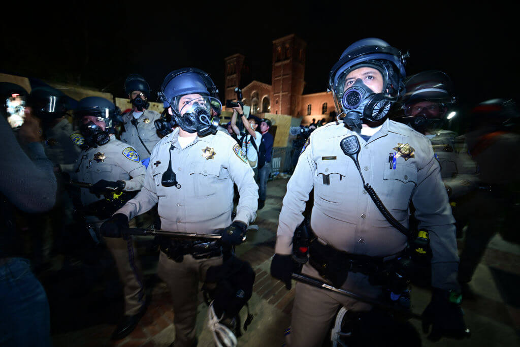 Police officers stand guard after clashes erupted on the campus of the University of California, Los Angeles, on May 1.