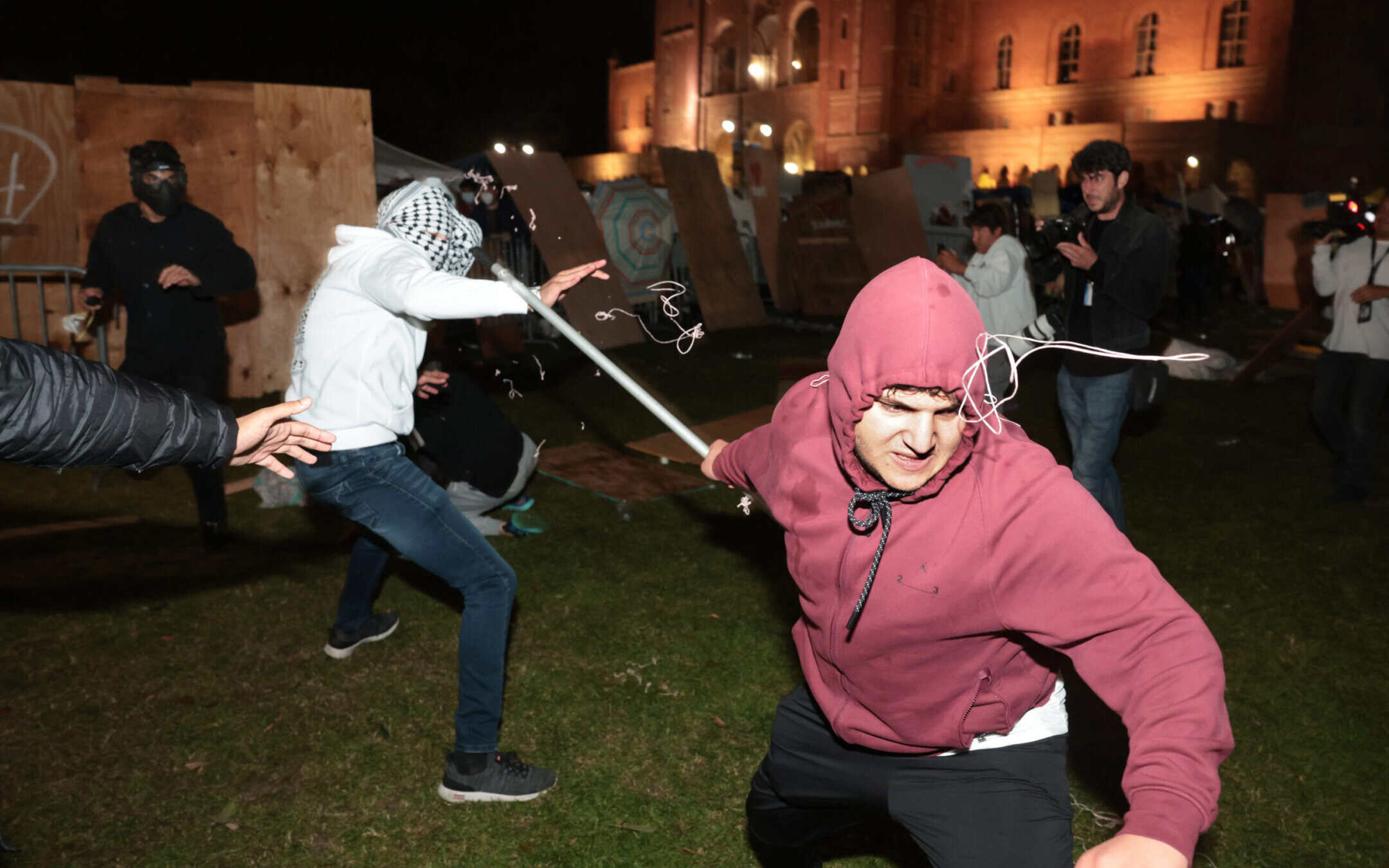 Pro-Palestinian and pro-Israel protesters clash during violence at an encampment at UCLA early in the morning of May 1, 2024. (Wally Skalij/Los Angeles Times via Getty Images)