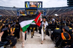 Salma Hamamy carries a Palestinian flag during a pro-Palestinian protest during the University of Michigan’s commencement ceremony on May 4, 2024 at Michigan Stadium in Ann Arbor, Michigan. (Nic Antaya/Getty Images)