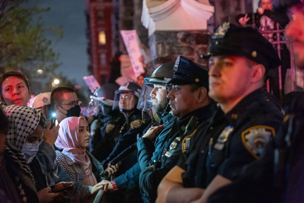 Pro-Palestinian protesters confront police at City College in New York City on April 30, 2024.