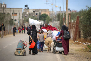 Displaced Palestinians in Rafah in Gaza carry their belongings as they leave following an evacuation order by the Israeli army on May 6.