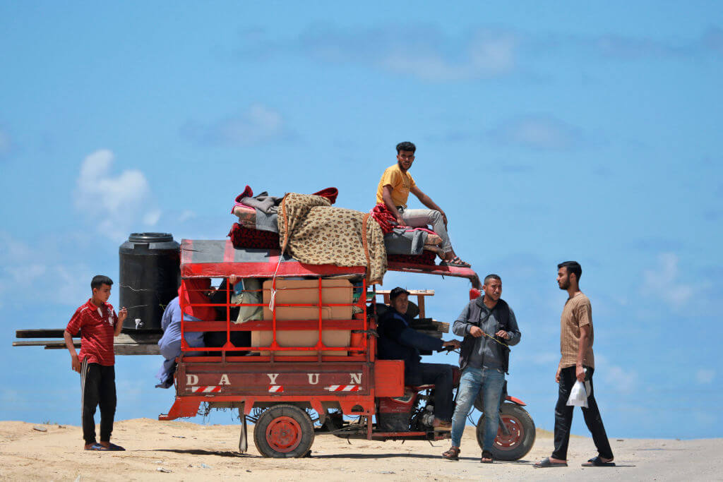 Palestinians who left Rafah after an evacuation order arrive in Khan Yunis with their belongings.