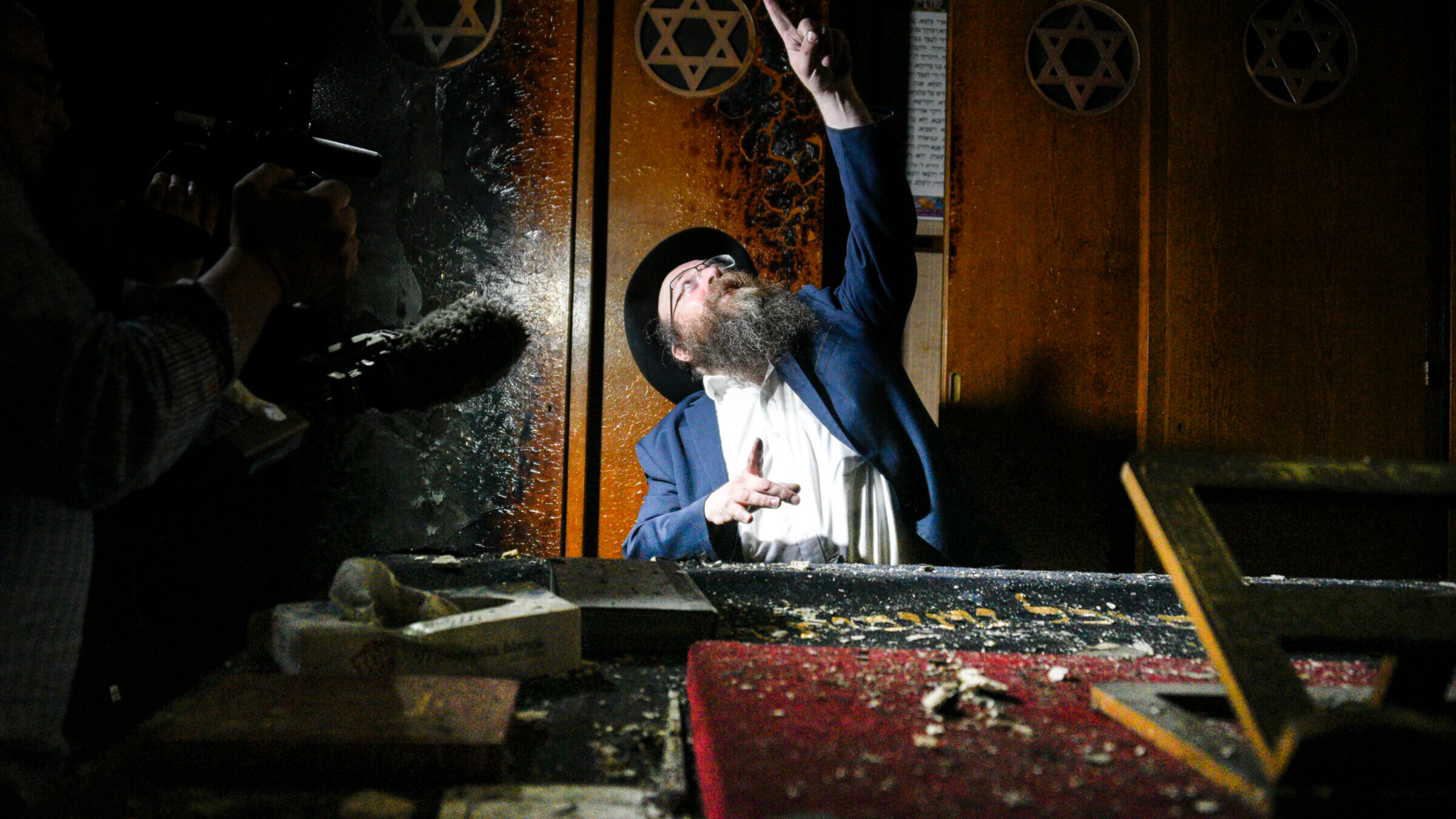 The rabbi of Rouen, Chmouel Lubecki, shows the fire damage in Rouen's main synagogue.