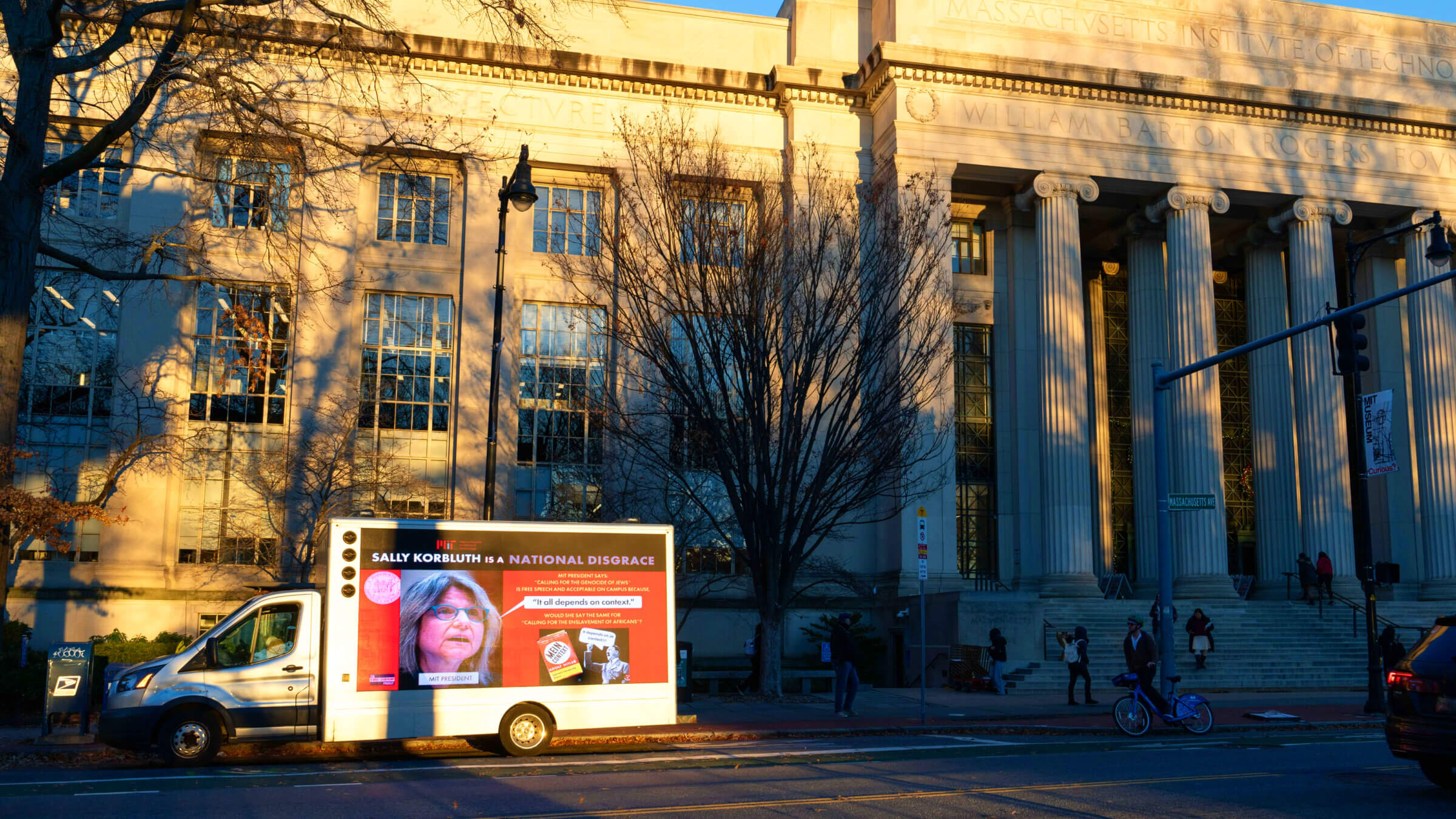 A truck with a sign reading "Sally Korbluth is a national disgrace" drives through the MIT campus in Cambridge, Massachusetts on Dec. 12, 2023. 