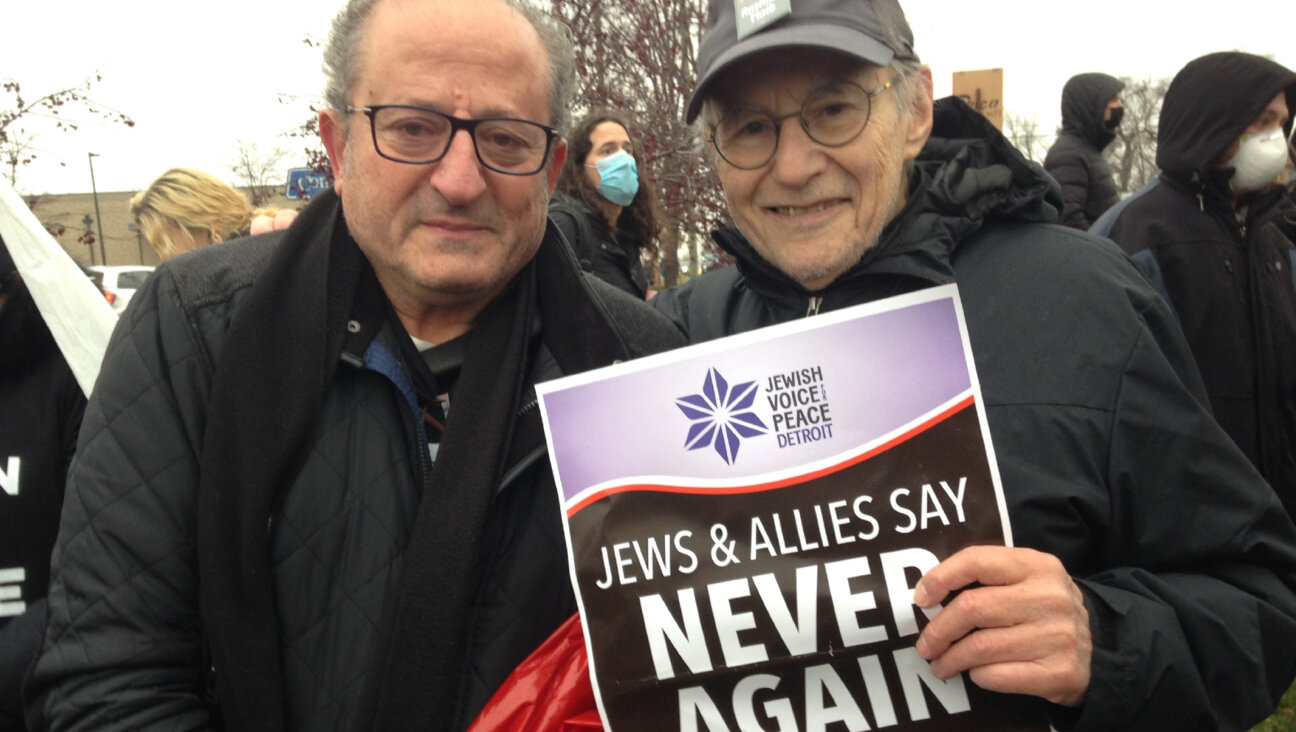 Rene Lichtman, <i>right</i>, poses with Palestinian activist Nabil Sater at a suburban Detroit ceasefire protest in December, where both men laid down in the street together to raise awareness.