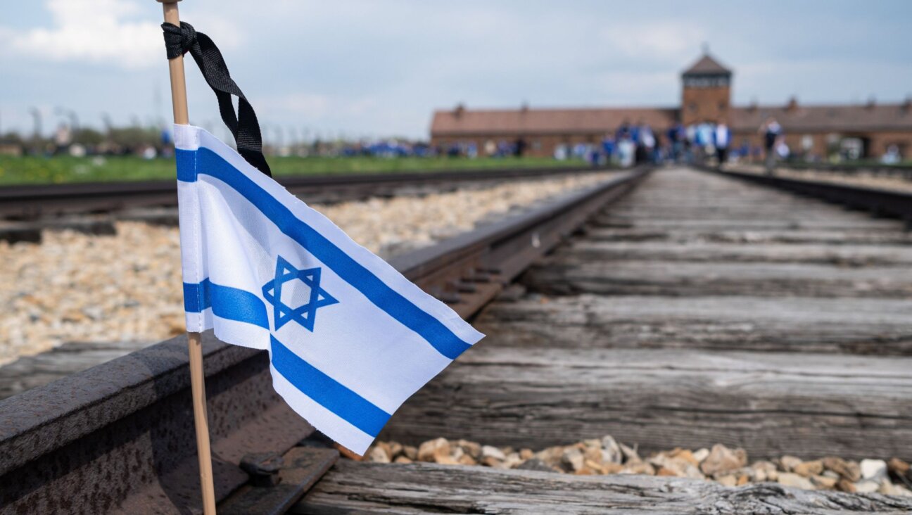 A flag of Israel was seen on the railroad tracks in KL Birkenau during the International March of The Living, April 28, 2022. (Wojciech Grabowski/SOPA Images/LightRocket via Getty Images)