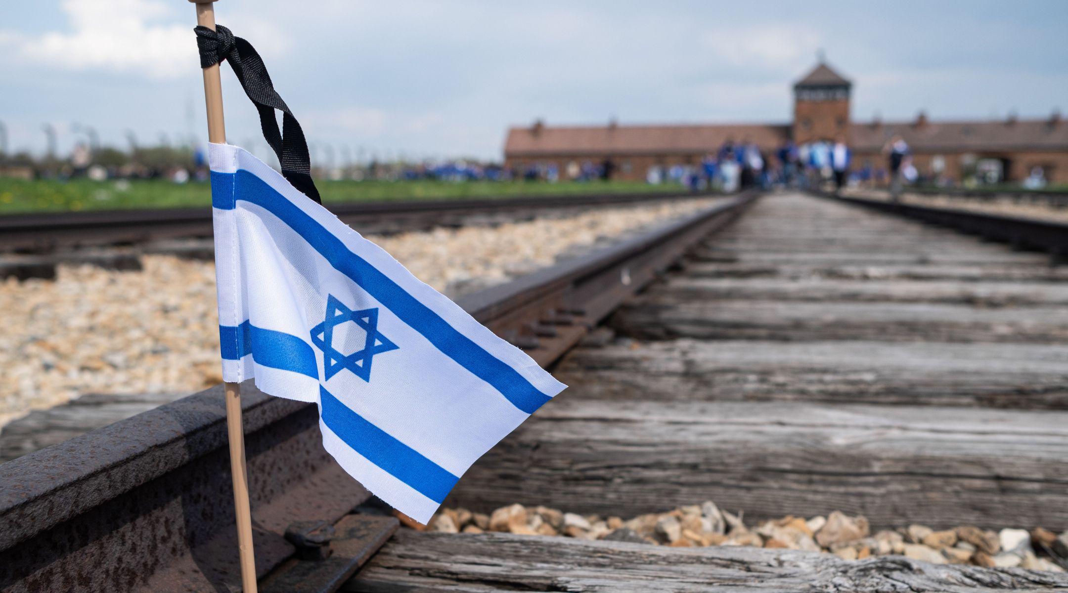 A flag of Israel was seen on the railroad tracks in KL Birkenau during the International March of The Living, April 28, 2022. (Wojciech Grabowski/SOPA Images/LightRocket via Getty Images)