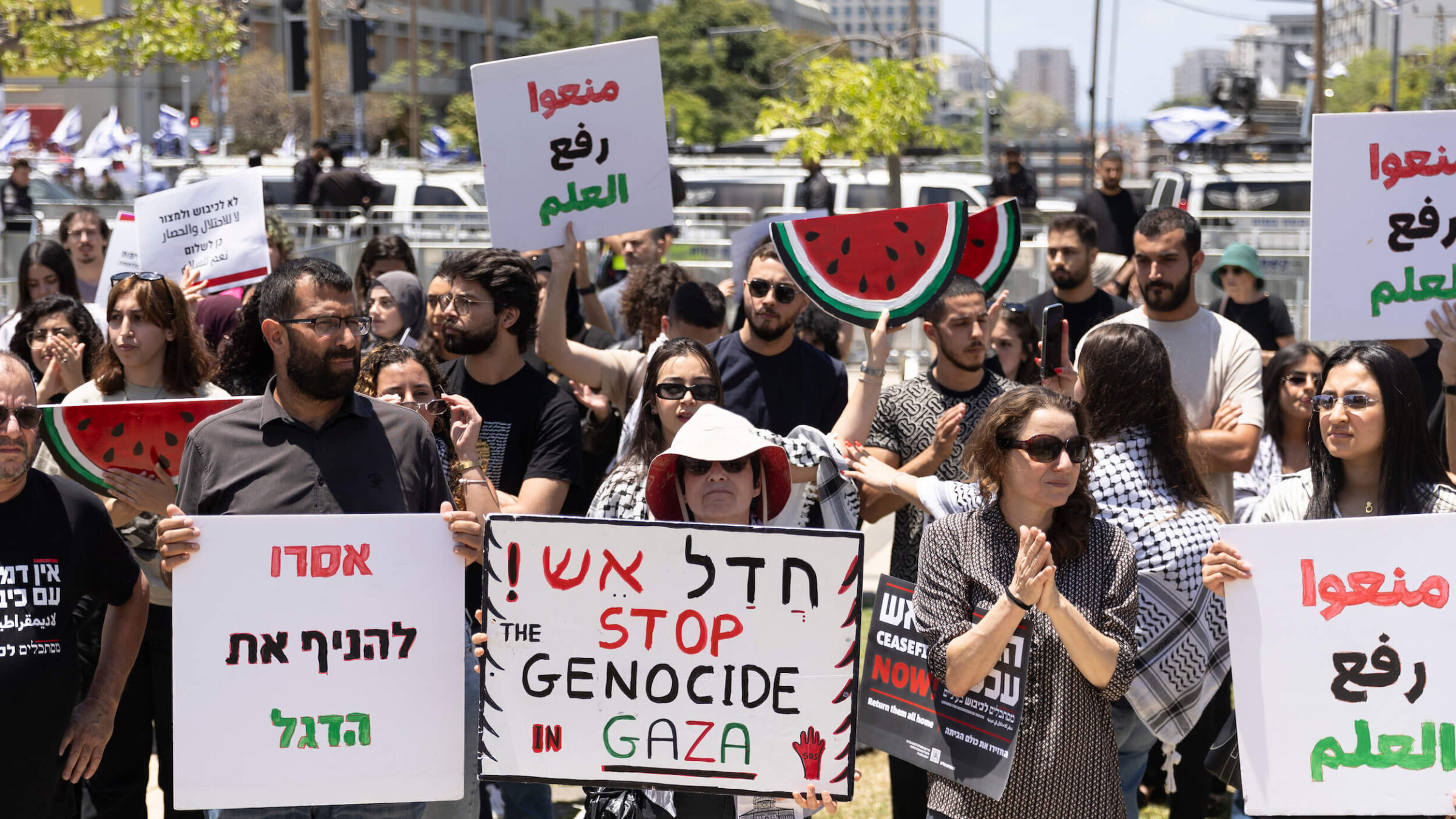 Pro-Palestinian activists hold signs during a rally to mark Nakba Day at Tel Aviv University on May 15.