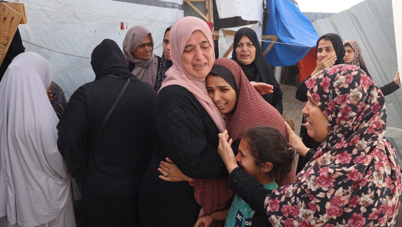 Palestinians mourn after an Israeli strike on a camp for internally displaced people in Rafah, Gaza, killed at least 45 people.