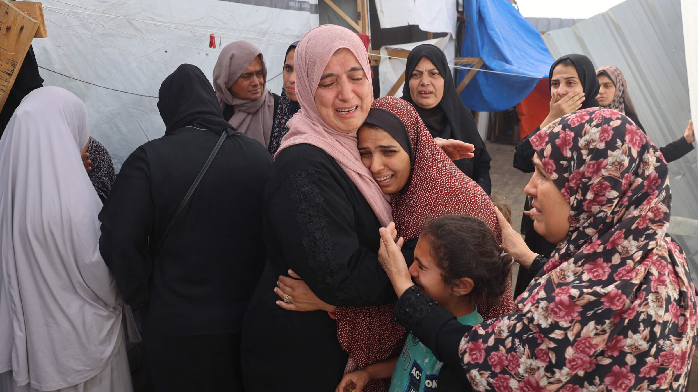 Palestinians mourn after an Israeli strike on a camp for internally displaced people in Rafah, Gaza, killed at least 45 people.