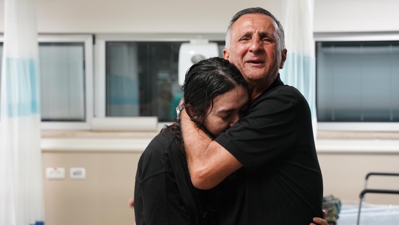 Noa Argamani embraces her father, Yaakov, after her rescue from captivity, June 8 2024. (Israeli Army Spokesman)