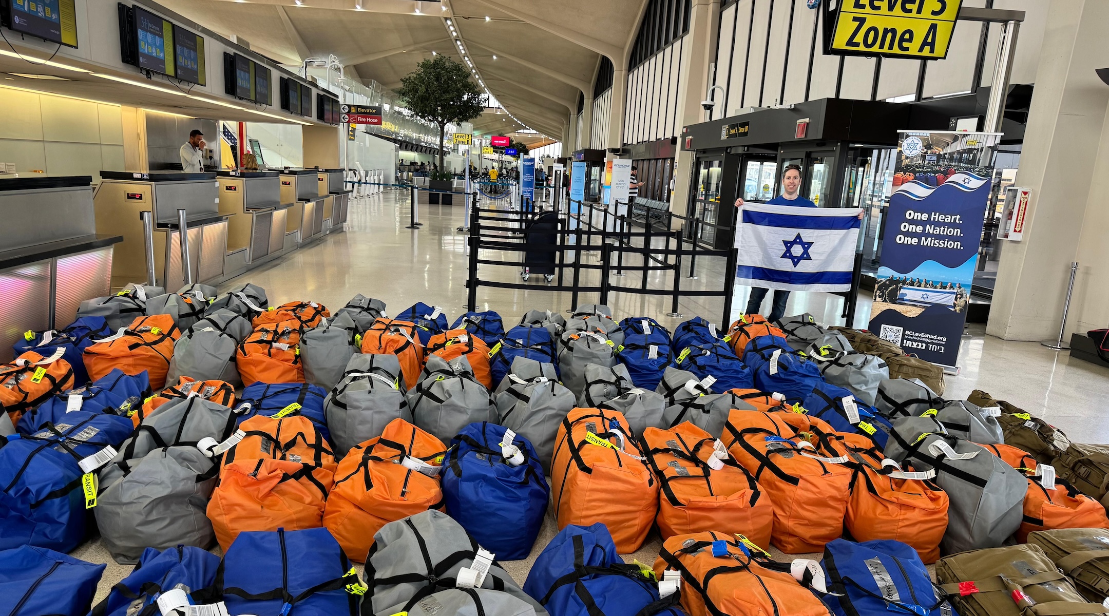 Duffle bags full of donated equipment organized by Bergen County Lev Echad are laid out for transport to Israel at Newark Liberty International Airport, April 10, 2024 (Courtesy of Bergen County Lev Echad)