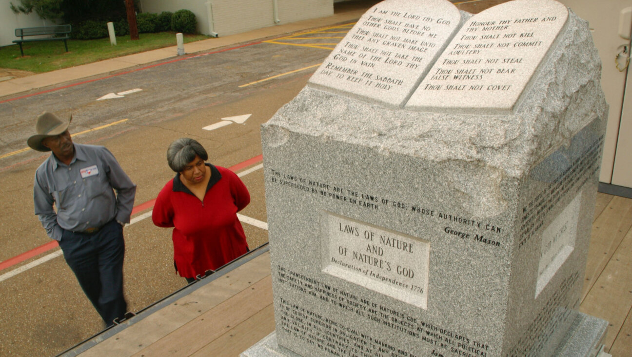 A couple views the granite Ten Commandments monument that was removed in 2003 from the Alabama Judicial Building November 16, 2004 in Longview, Texas. 