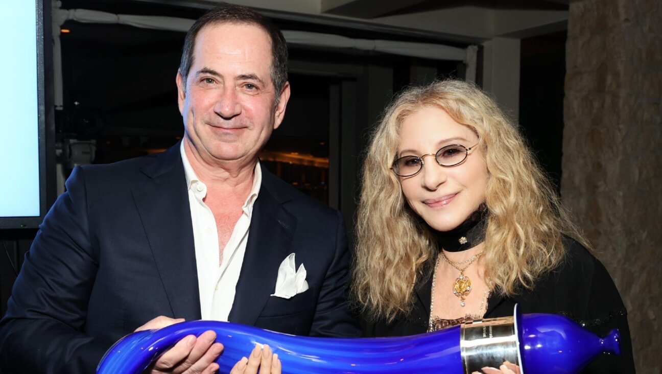 Barbra Streisand, winner of the Genesis Prize, receives a glass sculpture of a shofar from Genesis Prize Foundation co-founder Stan Polovets at a ceremony in Los Angeles, June 6, 2024. (Kevin Mazur/Getty Images for Genesis Prize Foundation)