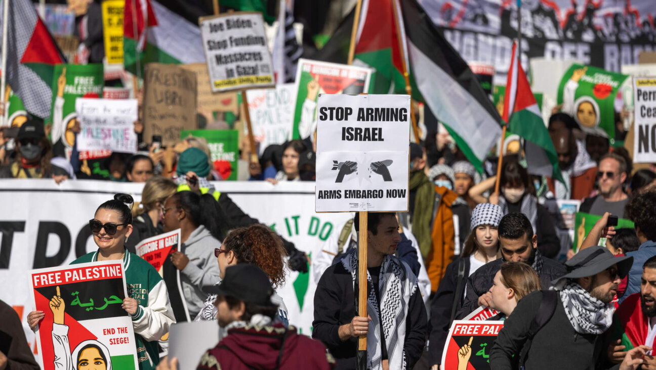 A protestor holds a sign reading "Stop Arming Israel" at a Los Angeles, California, rally against the war.