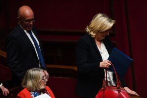 President of the French conservative party Les Republicains and member of Parliament Eric Ciotti and far-right National Rally president Marine Le Pen attend a session of the National Assembly in Paris, April 4, 2023. Ciotti announced in June 2024 that he would consider allying with Le Pen, shattering French political norms. (Christophe Archambault / AFP via Getty Images)