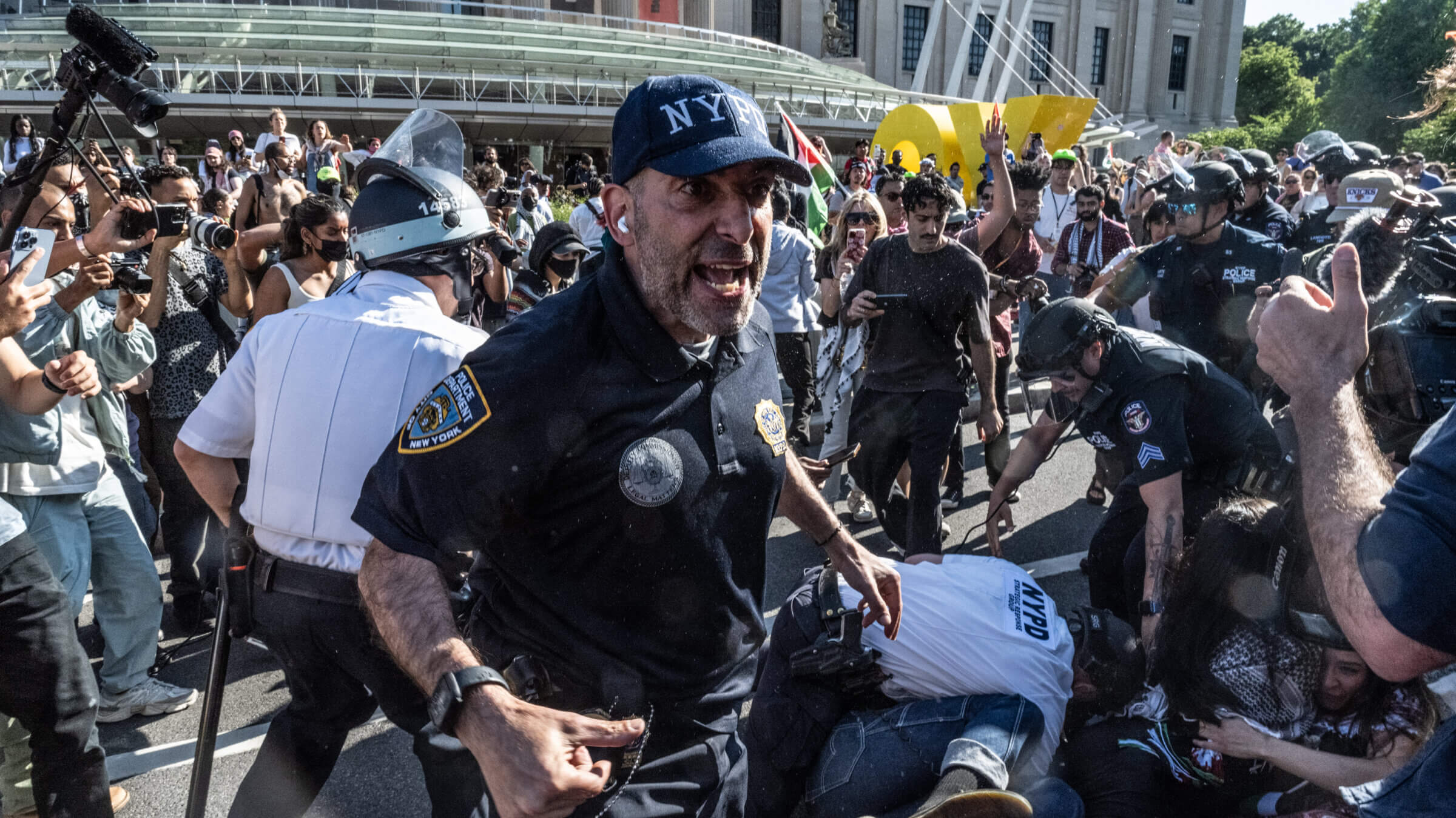 Police arrest protesters outside the Brooklyn Museum on May 31. Activists vandalized the homes of four museum leaders last week and initial reports said that all the officials targeted were Jewish.