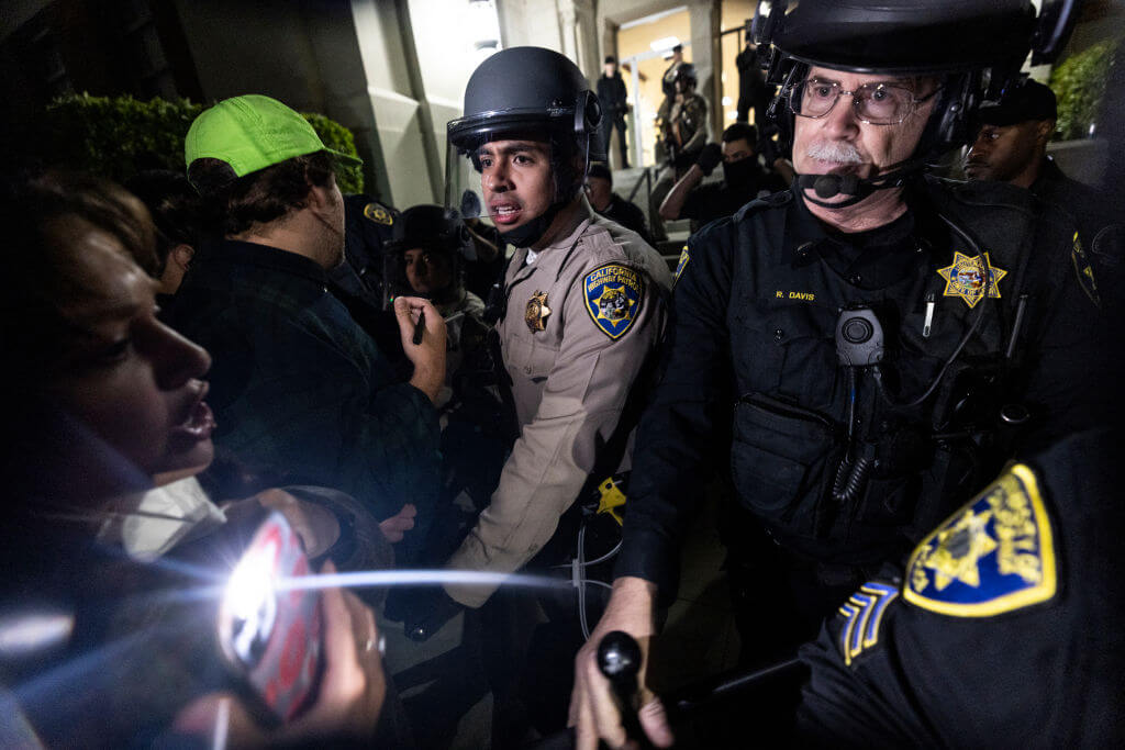 University of California Police and California Highway Patrol officers face pro-Palestinian protesters outside Dodd Hall at UCLA on June 10. Several protesters were arrested.