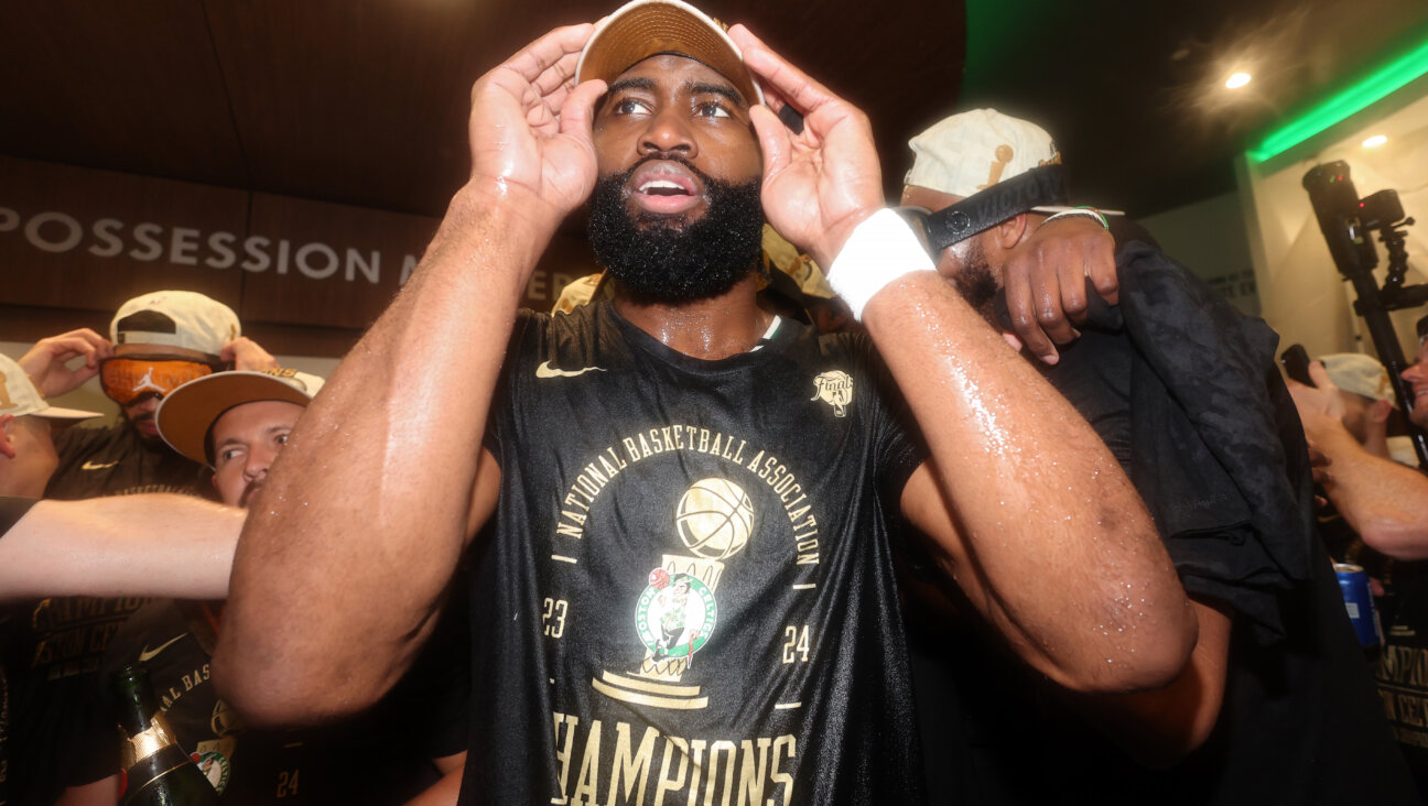 The Boston Celtics' Jaylen Brown celebrates in his team's locker room after the Celtics won the 2024 NBA Finals. Brown was named NBA Finals MVP.