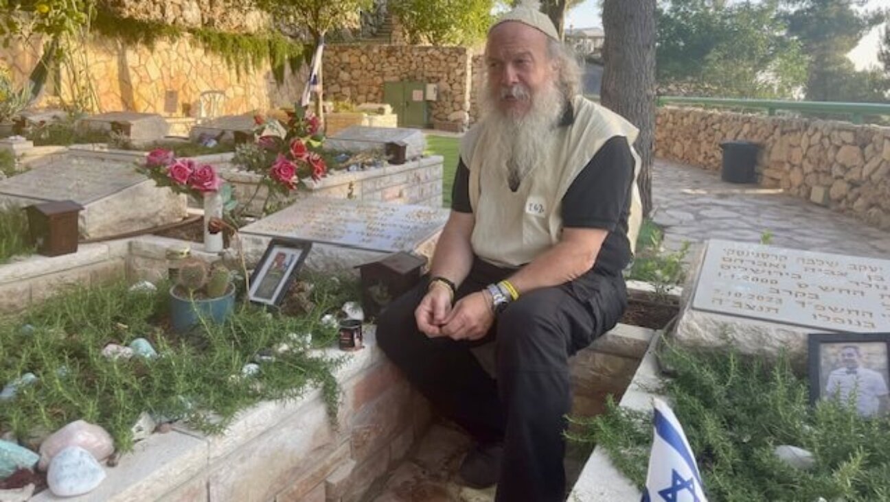 Yisrael Campbell visits the grave of a friend killed in Hamas' Oct. 7 attack. He since has attend funerals for at least two dozen fallen soldiers on Mount Herzl, Israel's national cemetery.