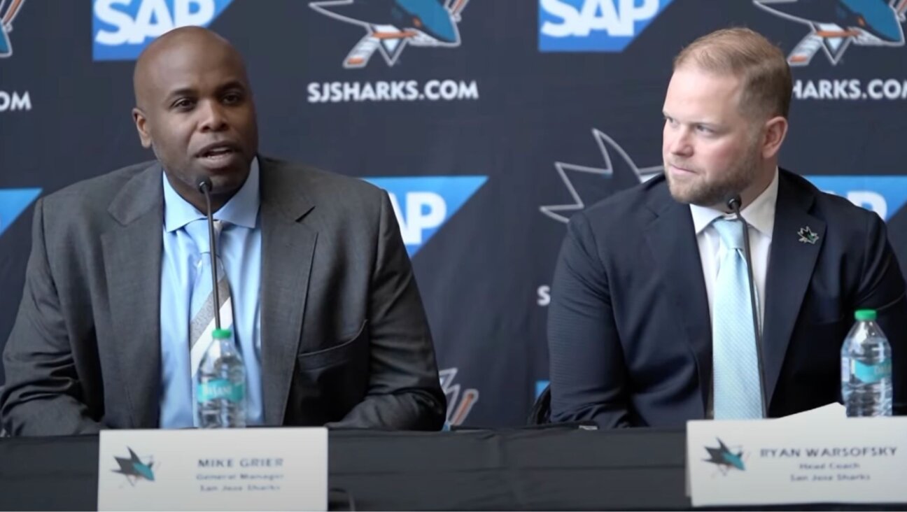 San Jose Sharks General Manager Mike Grier, left, introduces Ryan Warsofsky, right, as the Sharks’ new head coach at a press conference, June 17, 2024. (Screenshot from YouTube/Via NBC Sports Bay Area & California)