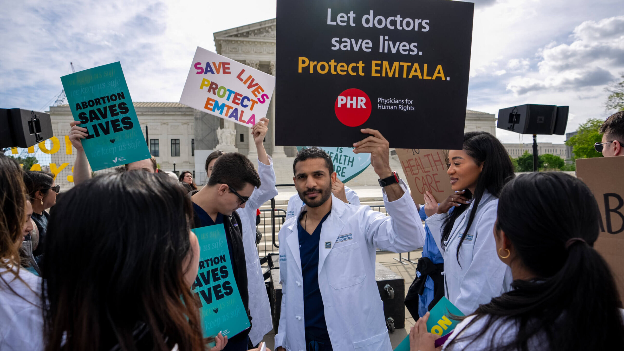 A group of doctors join abortion rights supporters at a rally outside the Supreme Court. The Court heard oral arguments on a case to decide if Idaho emergency rooms can provide abortions to women in a pregnancy emergency, April 24, 2024 in Washington, DC. 