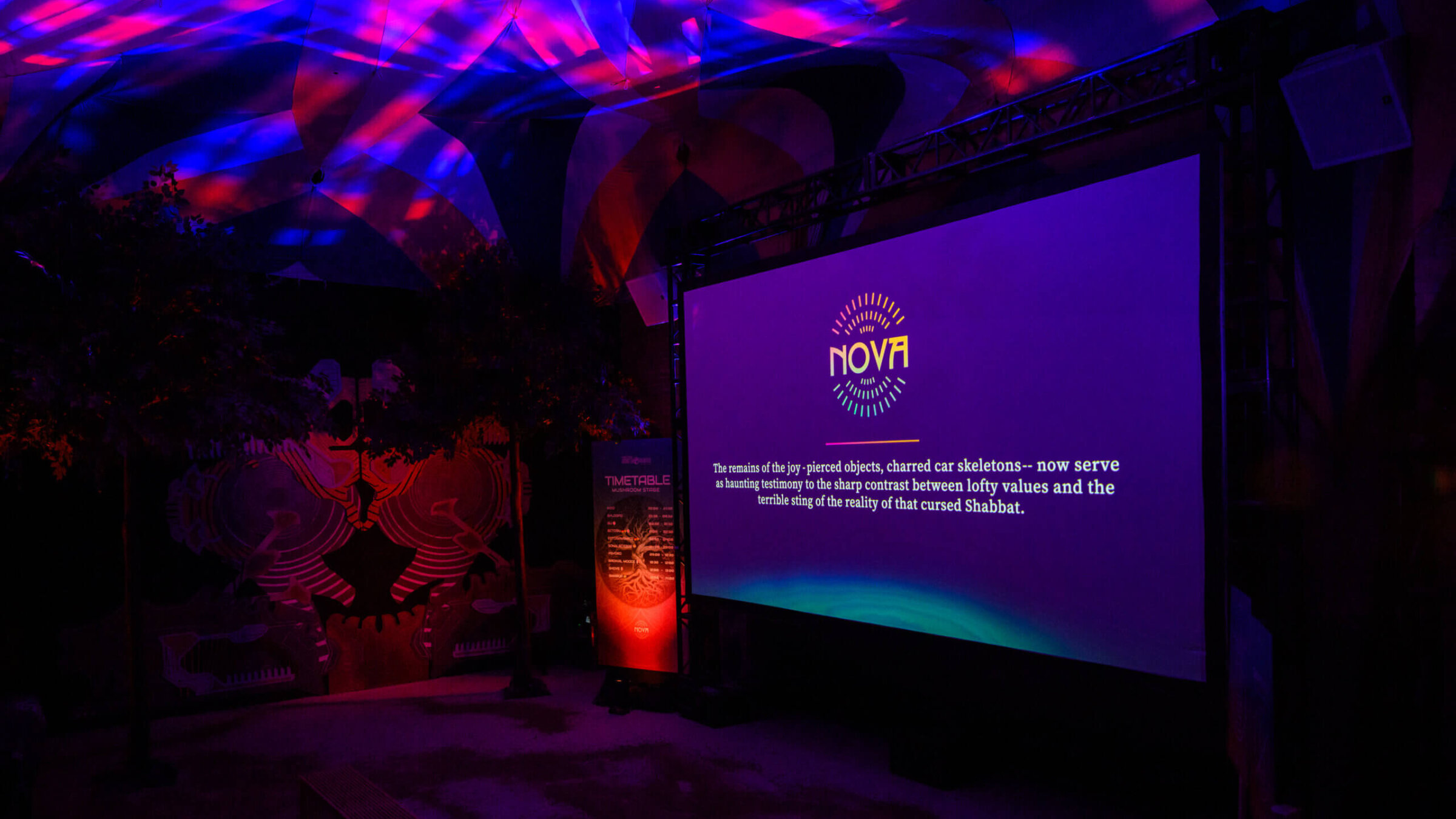 A screen displays info about the Nova festival at <i>The Nova Music Festival Exhibition: October 7th 06:29 AM, The Moment Music Stood Still</i>.