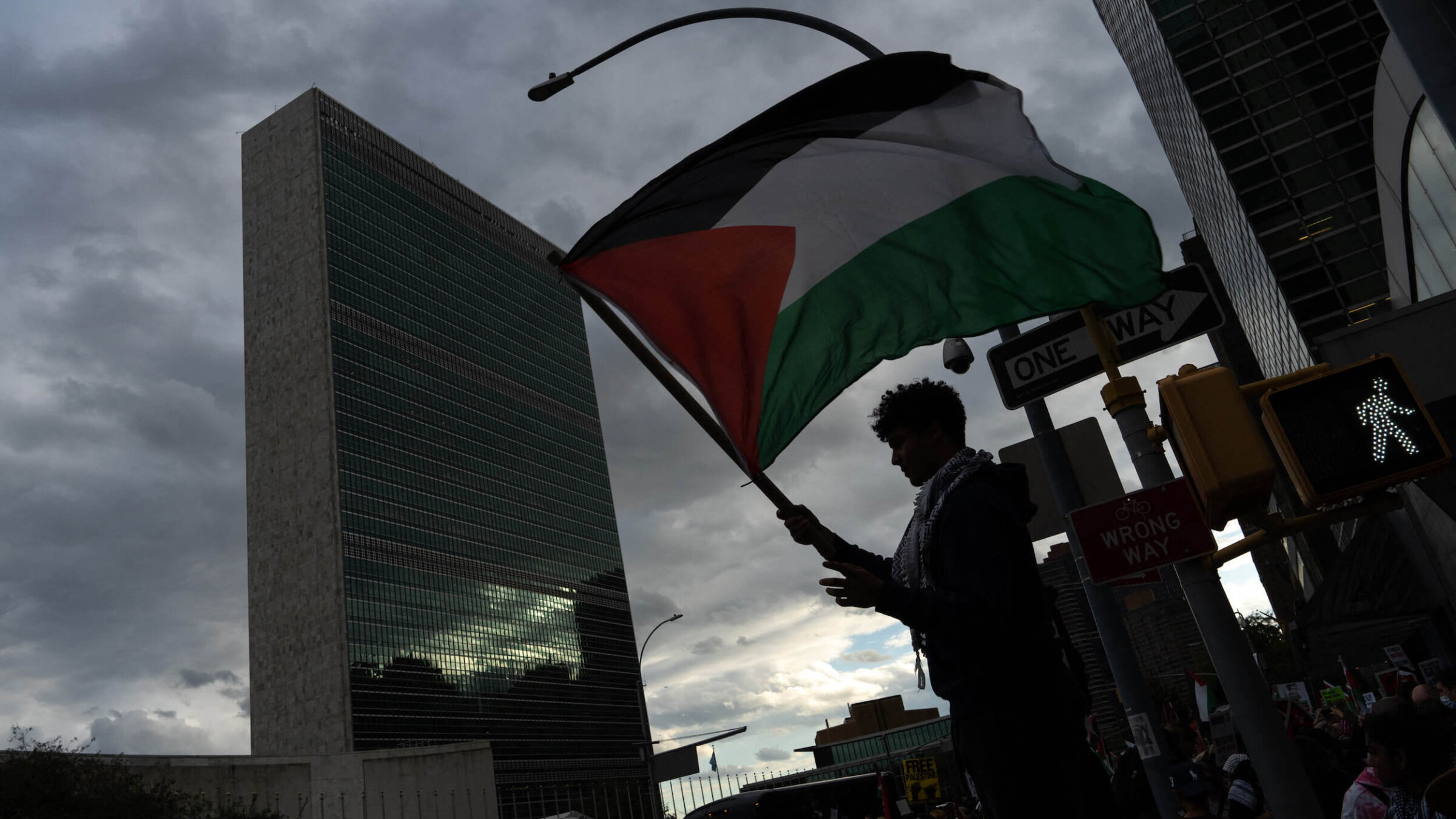 A demonstrator waves a Palestinian flag outside of the United Nations' headquarters.